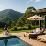 Peaceful Australian wellness retreat with infinity pool, yoga deck, and mountain views surrounded by lush greenery.